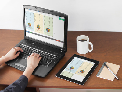 Photo of a laptop and tablet showing three and two columns of a calculator, respectively